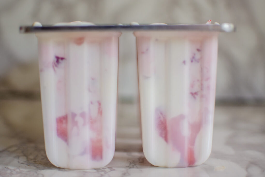 Greek Yogurt popsicles studded with fresh strawberry slices.