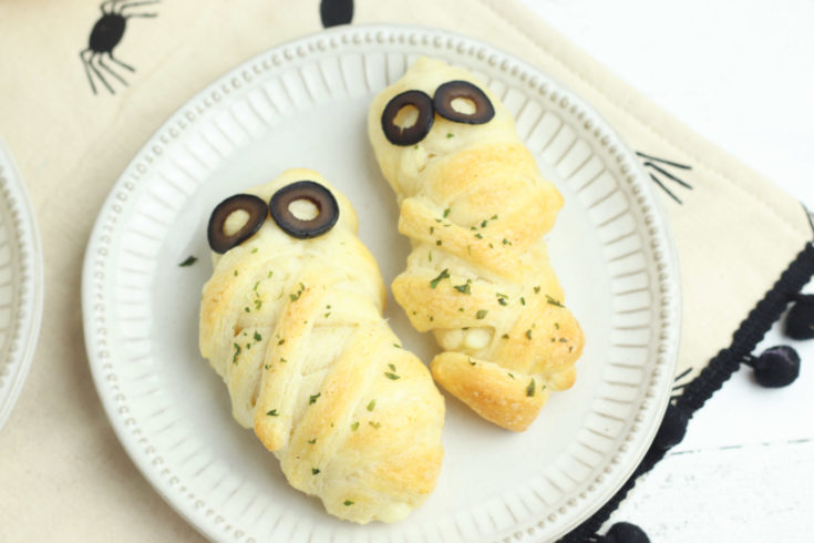 Cheese Stuffed Mummy Breadsticks with olive slices for eyes. A Halloween treat!